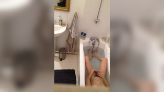 Horny girl fingering her hairy pussy in the bathtu