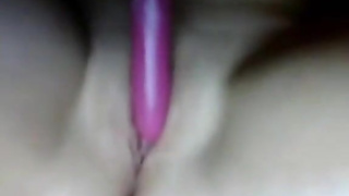 Bored girl plays with a pink dildo (claim)