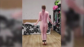 Naked girl jumps rope with ankles and toes tied