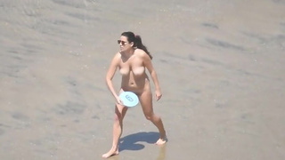 Playing frisbee totally nude at the beach