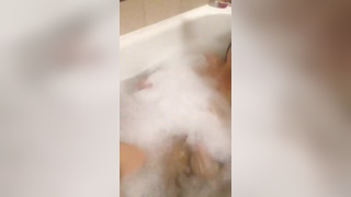 Girl in bath tries to cover up with bubbles