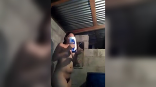 Cute girl streams herself taking a shower in shed