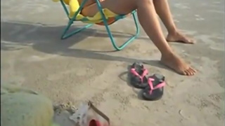 Husband films wife at beach in micro-bikini
