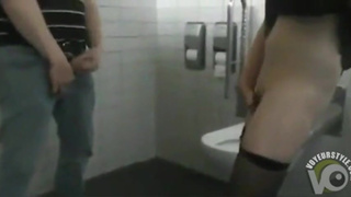 Girl masturbates in men's toilet in front of guys
